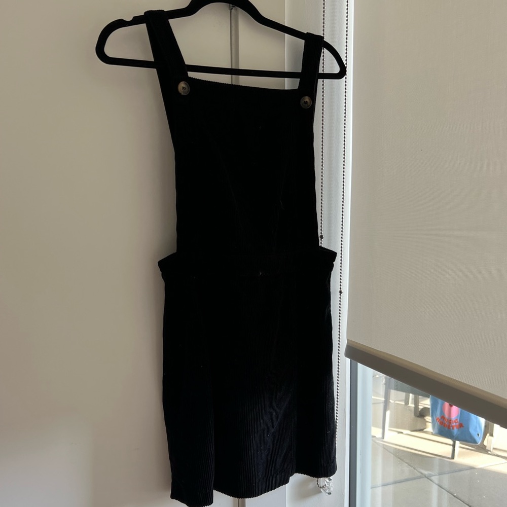 Black overalls style - in the shape of a dress.